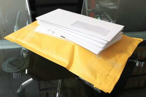 pile of paper mails over parcel post in office